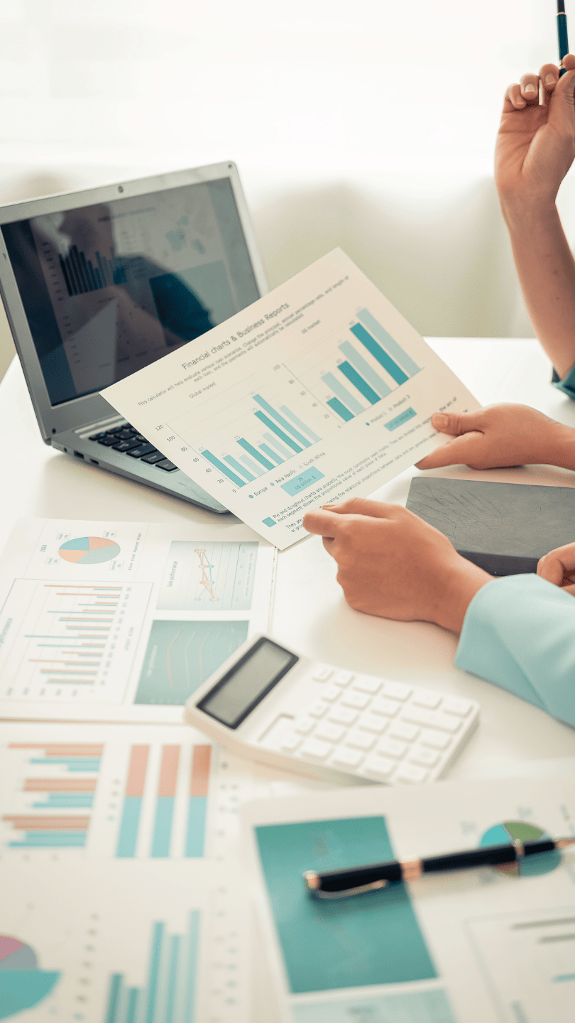 Let's work together image of two people looking over charts with a laptop.
